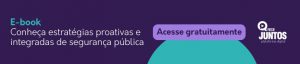 A arte tem um fundo roxo escuro com letras verde e branca em que se lê "e-book. conheça estratégias produtivas e integradas de segurança pública". Ao lado, vemos um botão lilás com letras roxas em que se lê "acesse gratuitamente". Ao lado, vemos em branco o logo da Rede Juntos