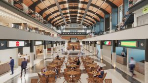 Imagem do projeto arquitetônico do Mercado de Santos. Na imagem, vemos o espaço interno do Mercado com cadeiras dispostas no centro, lojas na lateral e pessoas caminhando.